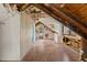 Unfinished attic space with hardwood flooring, dormer windows and exposed ceiling beams at 104 N Park Pl, Edgewater, FL 32132