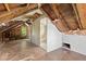 Unfinished attic room with hardwood flooring, a bathroom and exposed ceiling beams at 104 N Park Pl, Edgewater, FL 32132