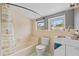 Small, outdated bathroom with a shower-tub combo and window at 104 N Park Pl, Edgewater, FL 32132