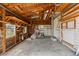 Unfinished garage interior shows wood framework, concrete floor, and ample space at 104 N Park Pl, Edgewater, FL 32132