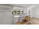 Outdated kitchen with double stainless sink and small microwave at 104 N Park Pl, Edgewater, FL 32132