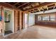 A living room with hardwood flooring, exposed beams, and access to a bathroom at 104 N Park Pl, Edgewater, FL 32132