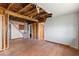 Open living room features hardwood floors, staircase, and exposed ceiling framework at 104 N Park Pl, Edgewater, FL 32132