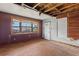 A view of the living room with a large window, hardwood floors, and front door at 104 N Park Pl, Edgewater, FL 32132