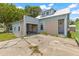 Back exterior view featuring convenient garage access and back door entrance, ready for renovation at 104 N Park Pl, Edgewater, FL 32132