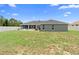 Large backyard with a fenced perimeter and patio area, offering privacy at 10800 Crescent Ridge Loop, Clermont, FL 34711
