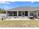 The backyard features a screened patio and ample space for entertaining and relaxation at 10800 Crescent Ridge Loop, Clermont, FL 34711