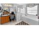 Bright Primary bathroom with a shower, tub, and vanity area at 10800 Crescent Ridge Loop, Clermont, FL 34711