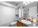 Cozy bathroom featuring a single sink vanity, white cabinets and ample lighting at 10800 Crescent Ridge Loop, Clermont, FL 34711
