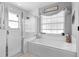Bright bathroom showcasing tub, shower, and window with decor at 10800 Crescent Ridge Loop, Clermont, FL 34711
