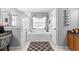 Well-lit bathroom featuring a large soaking tub, walk-in shower, and stylish decor at 10800 Crescent Ridge Loop, Clermont, FL 34711