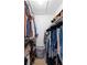 Walk-in closet featuring rods, shelves and organized personal items at 10800 Crescent Ridge Loop, Clermont, FL 34711