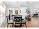 Cozy dining area featuring a stylish table set, pendant lighting, and natural light streaming in from nearby windows at 10800 Crescent Ridge Loop, Clermont, FL 34711
