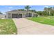 Charming single-story home with well-manicured lawn, basketball hoop and a two car garage at 10800 Crescent Ridge Loop, Clermont, FL 34711