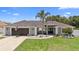 Charming single-story home with a well-maintained front yard and a basketball hoop over the garage at 10800 Crescent Ridge Loop, Clermont, FL 34711