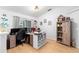 Functional home office with ample desk space, storage, and natural light from a large window at 10800 Crescent Ridge Loop, Clermont, FL 34711