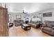 Comfortable living room with a ceiling fan, plush sofas, and multiple windows for natural light at 10800 Crescent Ridge Loop, Clermont, FL 34711