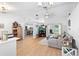 Open-concept living room featuring vaulted ceilings, wood-look flooring, and views into the modern kitchen at 10800 Crescent Ridge Loop, Clermont, FL 34711