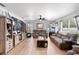 Spacious living room with wood-look tile flooring, neutral-toned furniture, and a ceiling fan for comfort at 10800 Crescent Ridge Loop, Clermont, FL 34711
