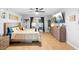 Bright bedroom with a king bed, access to the back yard, and a dresser at 10800 Crescent Ridge Loop, Clermont, FL 34711