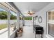 Enclosed patio with a ceiling fan and room for entertainment, leading to the backyard at 10800 Crescent Ridge Loop, Clermont, FL 34711