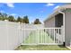 A fully fenced yard with white vinyl fencing and artificial turf at 10800 Crescent Ridge Loop, Clermont, FL 34711