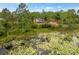 Picturesque aerial view of a property nestled near a serene pond, surrounded by lush greenery and natural beauty at 1092 Gage Ave, Deltona, FL 32738