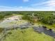 Aerial view of a property with a serene pond, lush greenery, and a tranquil atmosphere at 1092 Gage Ave, Deltona, FL 32738