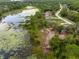 Beautiful aerial view of a neighborhood with well-maintained homes nestled near a serene pond and lush greenery at 1092 Gage Ave, Deltona, FL 32738