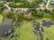 An aerial view showcasing the property's serene lakeside setting with surrounding greenery and neighborhood at 1092 Gage Ave, Deltona, FL 32738