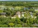 Aerial view of homes on lots with large driveways near a body of water at 1092 Gage Ave, Deltona, FL 32738