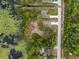 Aerial view of a neighborhood with well-maintained homes, serene pond, and lush greenery at 1092 Gage Ave, Deltona, FL 32738
