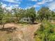 Overhead shot of a large, level backyard with shade trees and some brush at 1092 Gage Ave, Deltona, FL 32738