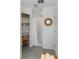 Clean bathroom with neutral tile floors, walk-in shower, decorative mirror, and built-in storage shelves at 1092 Gage Ave, Deltona, FL 32738