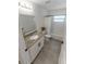 Beautiful bathroom featuring granite countertop, white cabinetry, framed mirror, and shower over tub combo at 1092 Gage Ave, Deltona, FL 32738