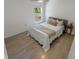 Simple bedroom with tile floors, a queen-sized bed, and a sunny window at 1092 Gage Ave, Deltona, FL 32738