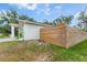 Landscaped backyard featuring a wood fence, lush greenery and tropical plants at 1092 Gage Ave, Deltona, FL 32738