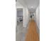 Hallway displaying tiled floors and white walls leading to a bedroom and kitchen with ample lighting at 1092 Gage Ave, Deltona, FL 32738