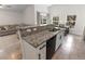 Stylish kitchen showcasing granite counters, stainless sink, and a seamless connection to living and dining areas at 1092 Gage Ave, Deltona, FL 32738