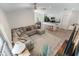 Bright living area featuring a large sectional sofa, stylish rug, and an open layout with kitchen views at 1092 Gage Ave, Deltona, FL 32738