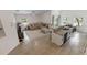 Open-concept space boasting wood-look tile floors, granite island, and views of living and dining area at 1092 Gage Ave, Deltona, FL 32738