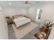 Cozy main bedroom featuring tile floors, neutral tones, ensuite bathroom, and ceiling fan at 1092 Gage Ave, Deltona, FL 32738