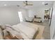 Well-lit main bedroom with tile floors, ceiling fan, neutral decor, and access to the outdoors at 1092 Gage Ave, Deltona, FL 32738