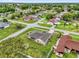 An aerial view captures a home in a neighborhood with swimming pools and mature tree coverage at 1101 Anderson St, Deltona, FL 32725