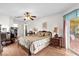 Spacious bedroom with a ceiling fan, dresser, and sliding doors to the lanai at 1101 Anderson St, Deltona, FL 32725