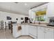 Clean kitchen showcasing white cabinets, stainless steel sink, and connection to dining area at 1101 Anderson St, Deltona, FL 32725