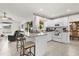 Open-concept kitchen with white cabinetry, breakfast bar, and view of the adjacent living area at 1101 Anderson St, Deltona, FL 32725