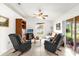 Cozy living room featuring tile flooring, a ceiling fan, and sliding glass doors to the lanai at 1101 Anderson St, Deltona, FL 32725