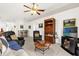 Inviting living area with comfortable seating, a wooden bookcase, and a view into the dining space at 1101 Anderson St, Deltona, FL 32725