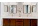 Bathroom featuring double sinks, cabinets, and wall mirrors at 112 Chelsea Place Ave, Ormond Beach, FL 32174